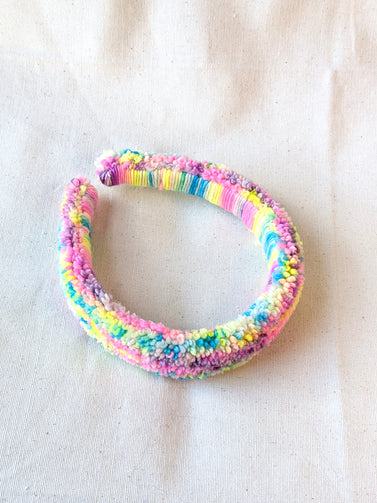 This is a detail image of a rainbow shaveded punch needle headband. The colors ranges from bright yellow to teal to pink to purple. Holo Rainbow Headband 01 | dancing arms | Punch Needle Headband
