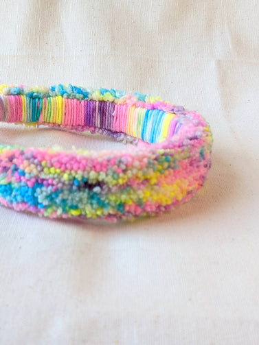 This is a detail image of a rainbow shaveded punch needle headband. The colors ranges from bright yellow to teal to pink to purple. Holo Rainbow Headband 01 | dancing arms | Punch Needle Headband
