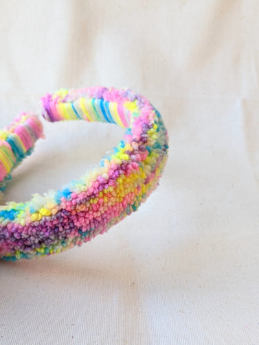 This is a detail image of a rainbow shaveded punch needle headband. The colors ranges from bright yellow to teal to pink to purple. Holo Rainbow Headband 01 | dancing arms | Punch Needle Headband