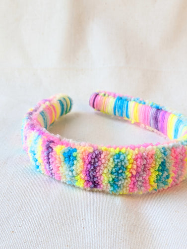 This is a detail image of a rainbow shaveded punch needle headband. The colors ranges from bright yellow to teal to pink to purple. Holo Rainbow Headband 01 | dancing arms | Punch Needle Headband