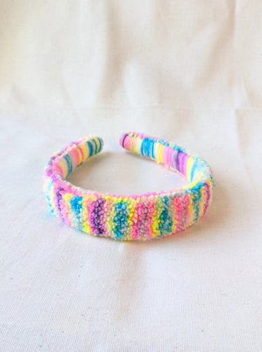 This is a detail image of a rainbow shaveded punch needle headband. The colors ranges from bright yellow to teal to pink to purple. Holo Rainbow Headband 01 | dancing arms | Punch Needle Headband