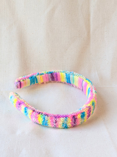This is a detail image of a rainbow shaveded punch needle headband. The colors ranges from bright yellow to teal to pink to purple. Holo Rainbow Headband 01 | dancing arms | Punch Needle Headband