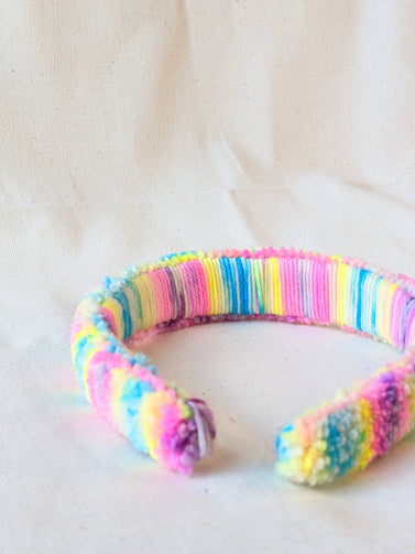 This is a detail image of a rainbow shaveded punch needle headband. The colors ranges from bright yellow to teal to pink to purple. Holo Rainbow Headband 01 | dancing arms | Punch Needle Headband