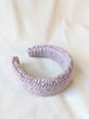 This is an image of a punch needle headband made with lavender chunky merino wool. Dancing arms punch needle hair accessories made in Los Angeles.