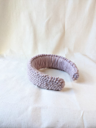 This is an image of a punch needle headband made with lavender chunky merino wool. Dancing arms punch needle hair accessories made in Los Angeles.