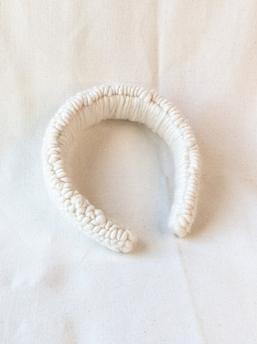 This is an image of a punch needle headband made with ivory chunky merino wool. Dancing arms punch needle hair accessories made in Los Angeles.