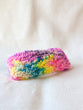 This is an image of a medium sized punch needle hair barrettes made with a rainbow yarn. Dancing arms punch needle hair accessories.