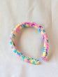 This is a detail image of a rainbow shaveded punch needle headband. The colors ranges from bright yellow to teal to pink to purple. Holo Rainbow Headband 01 | dancing arms | Punch Needle Headband